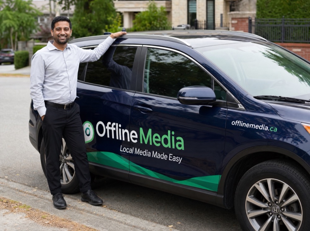 OfflineMedia driver next to a wrapped vehicle